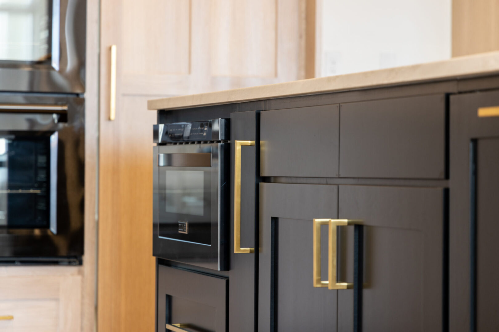 Kitchen cabinets and drawers painted in black and gold