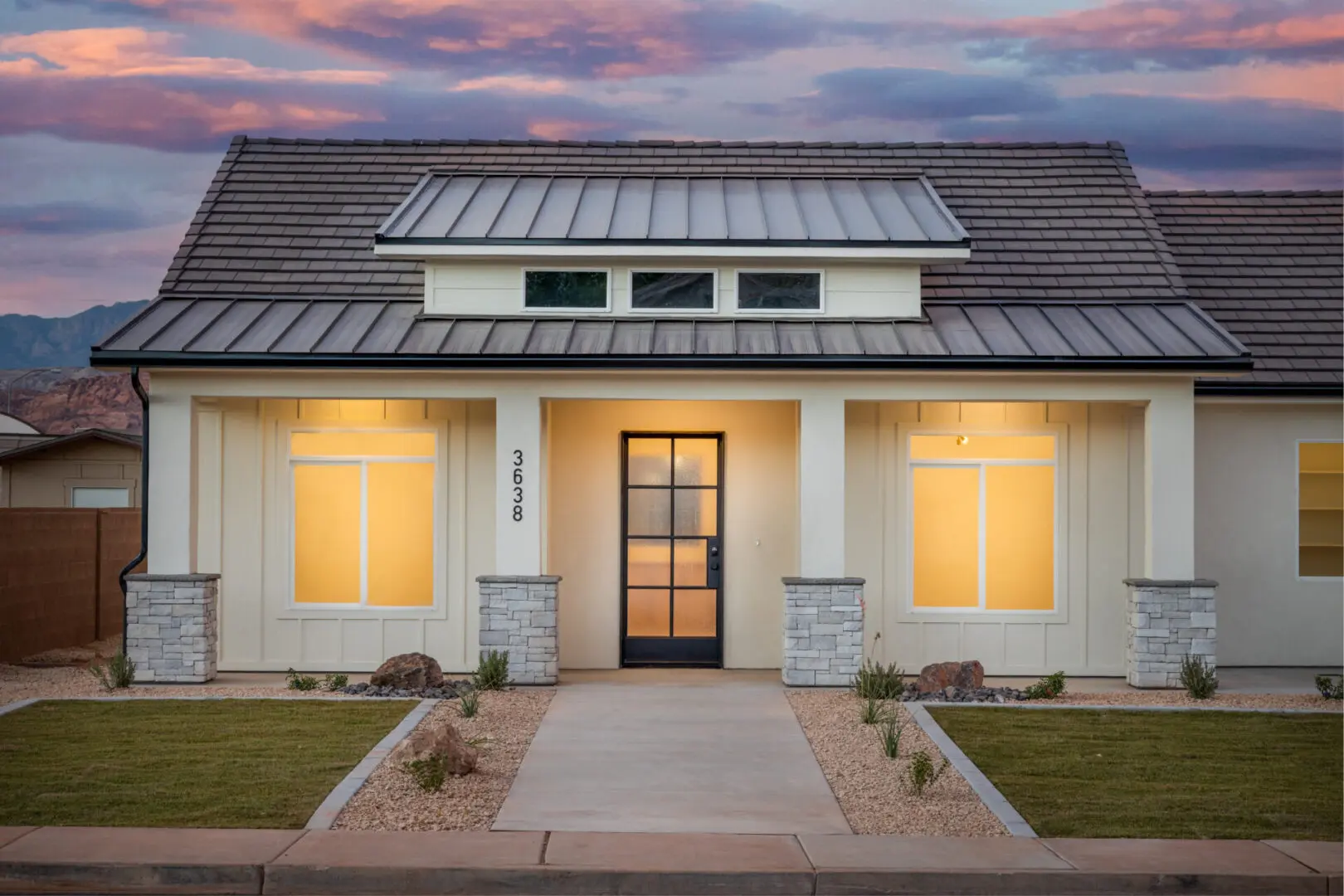 A house with white walls and dark roof